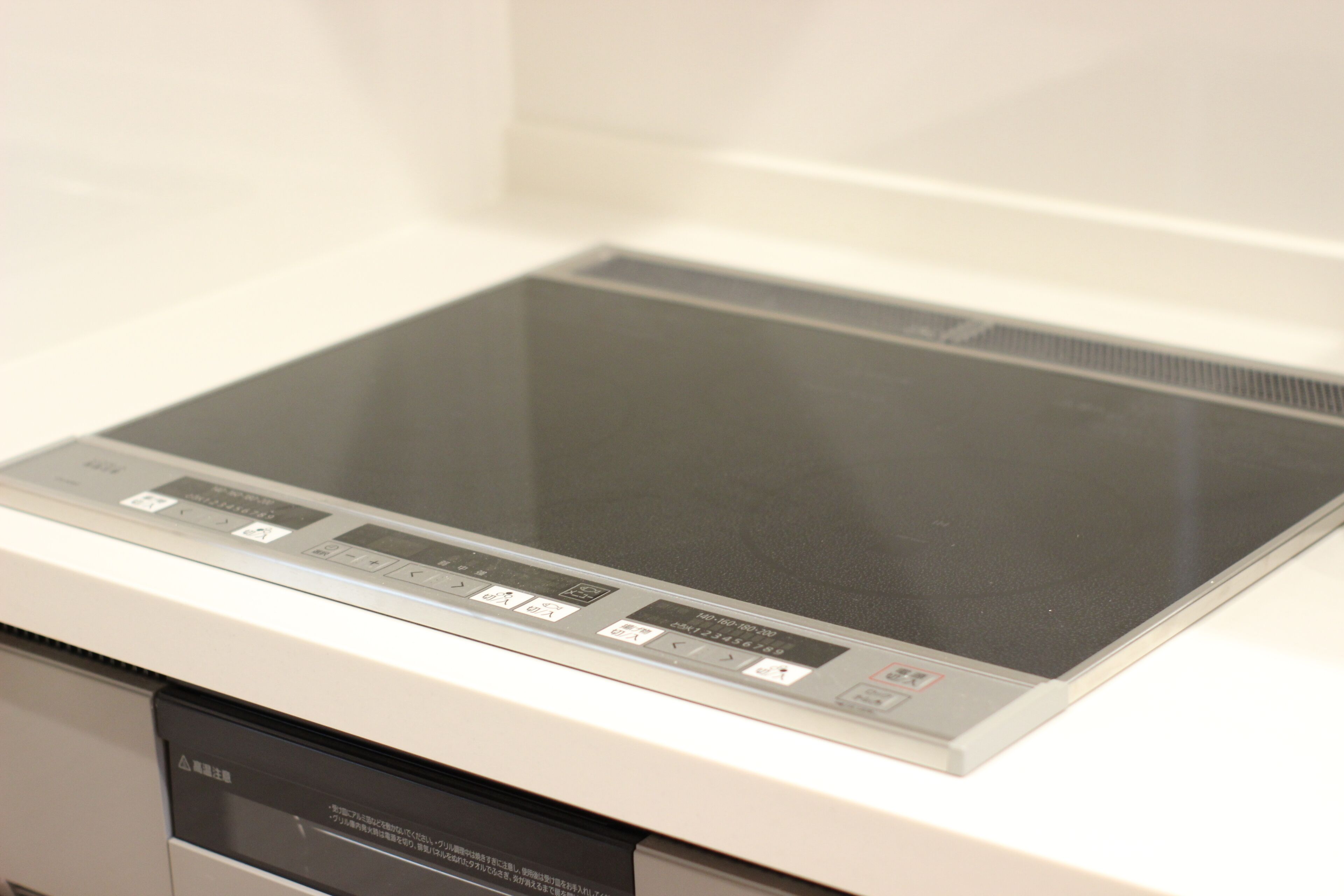 A kitchen with a built-in stove and a dishwasher.