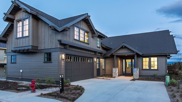 A modern two-story house with a garage, a fire hydrant, and a well-maintained driveway. - SUNNY VACAY ~ 24-hr staff ~ south views ~ BBQ ~ 🐶 ~ hot tub ~ Bend  (Bend)