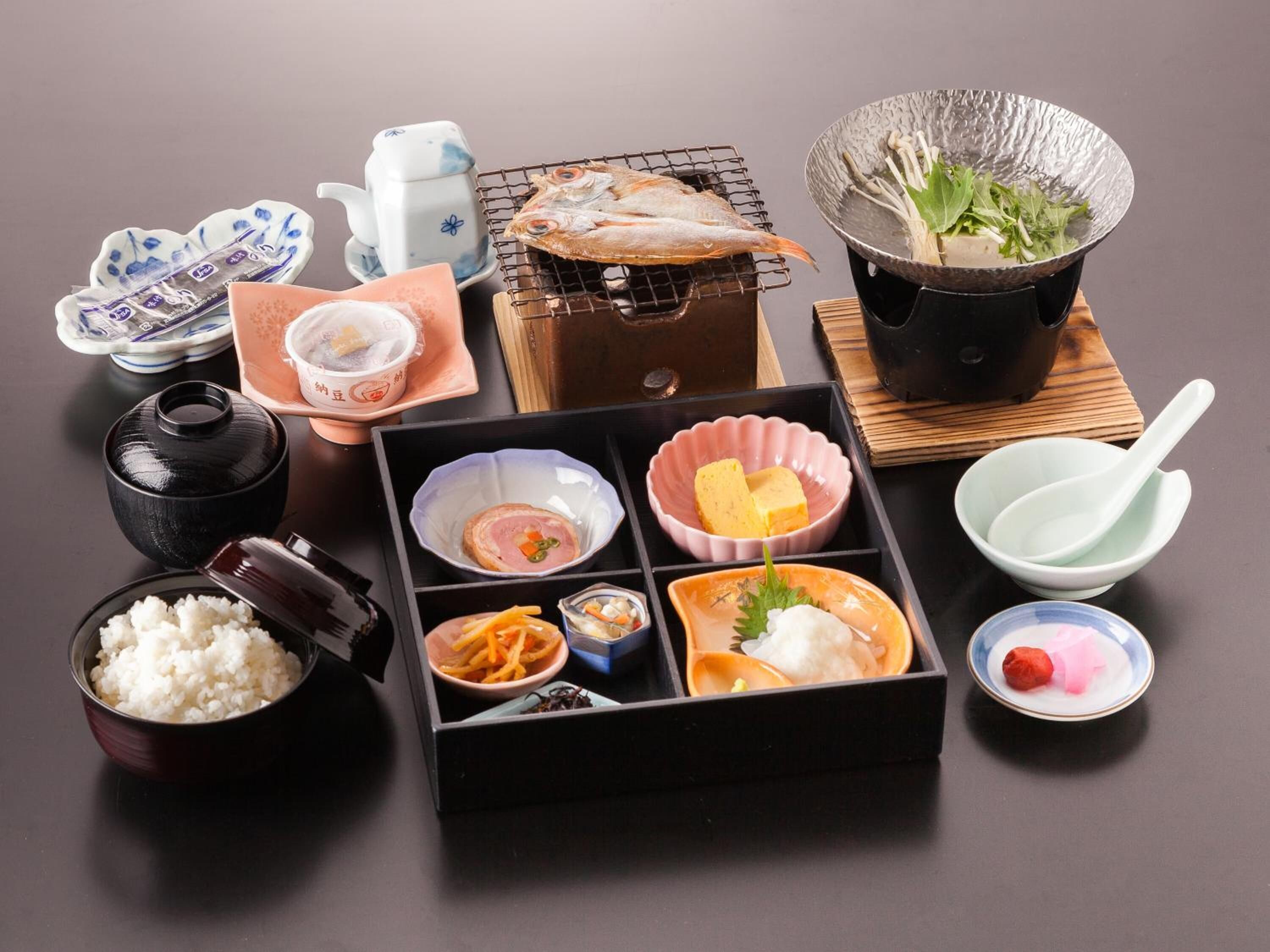 A traditional Japanese meal setup with various dishes and utensils.