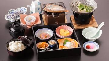 A traditional Japanese meal setup with various dishes and utensils.