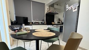 A modern kitchen with a dining area.