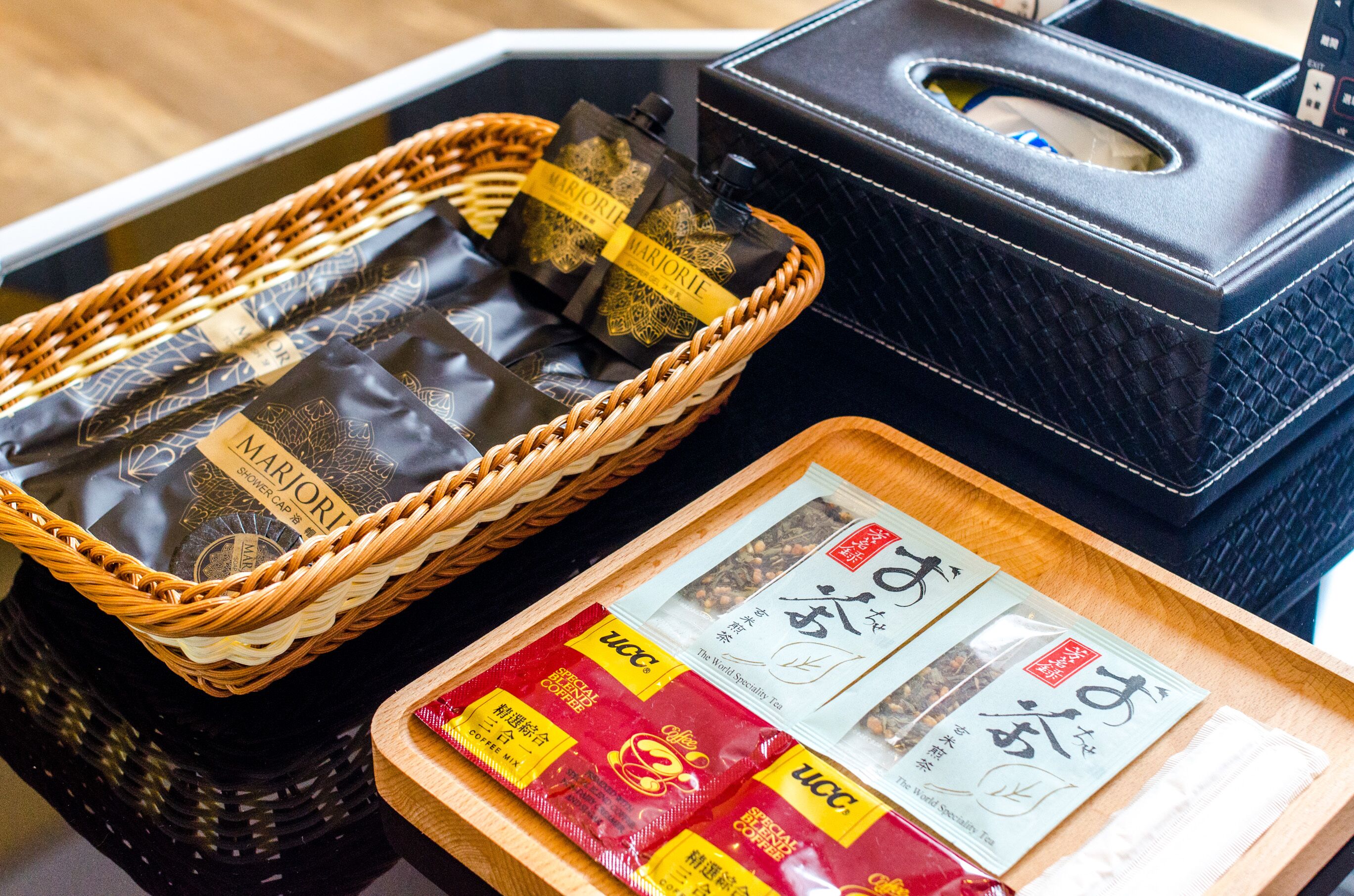 A wicker basket with black bags and a tray with tea packets.