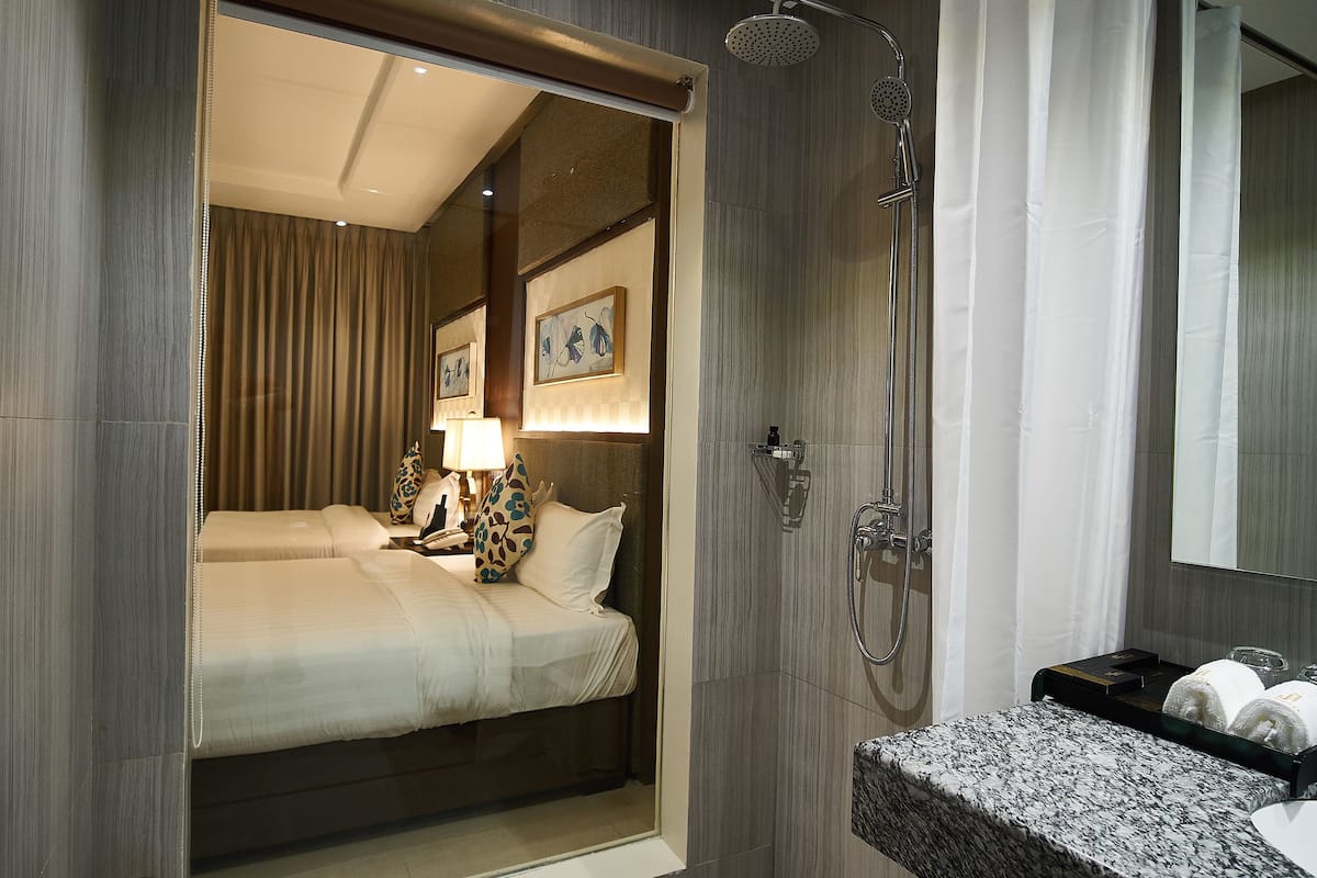 premier room | bathroom | shower, slippers, towels