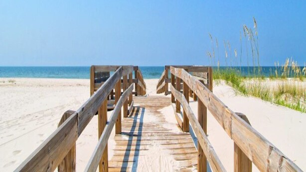 A wooden boardwalk leading to a beach with clear skies. - Closest to the Beach @ Lost Key + Game Room (Pensacola)
