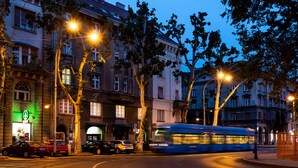 A street scene with a tram, parked cars, and buildings with classical architecture. - B&B Downtown Zagreb (Zagreb)