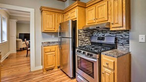 A kitchen with wooden cabinets, stainless steel appliances, and a tiled backsplash. - Spacious Mount Pleasant Home: 5 Mi to Beach (Mount Pleasant)