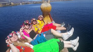 A group of people on a boat with a large decorative structure in the center.