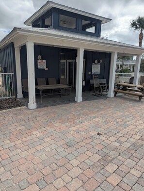 A covered outdoor seating area with benches and tables, a sign prohibiting children on duty, and a no driving sign. - Steinhatchee riverfront. Fishing, scalloping and relaxation yours for the asking (Steinhatchee)