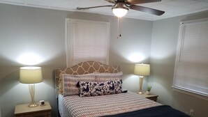 A bedroom with a bed, two bedside lamps, a ceiling fan, and a window with blinds. - Great location! 5 min. to Downtown, Medical District, and the Masters. (Augusta)