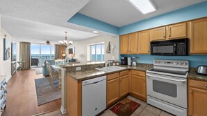 A modern kitchen with wooden cabinets, a built-in microwave, and a dishwasher.