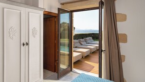 A room with a sliding glass door leading to a pool area with lounge chairs.