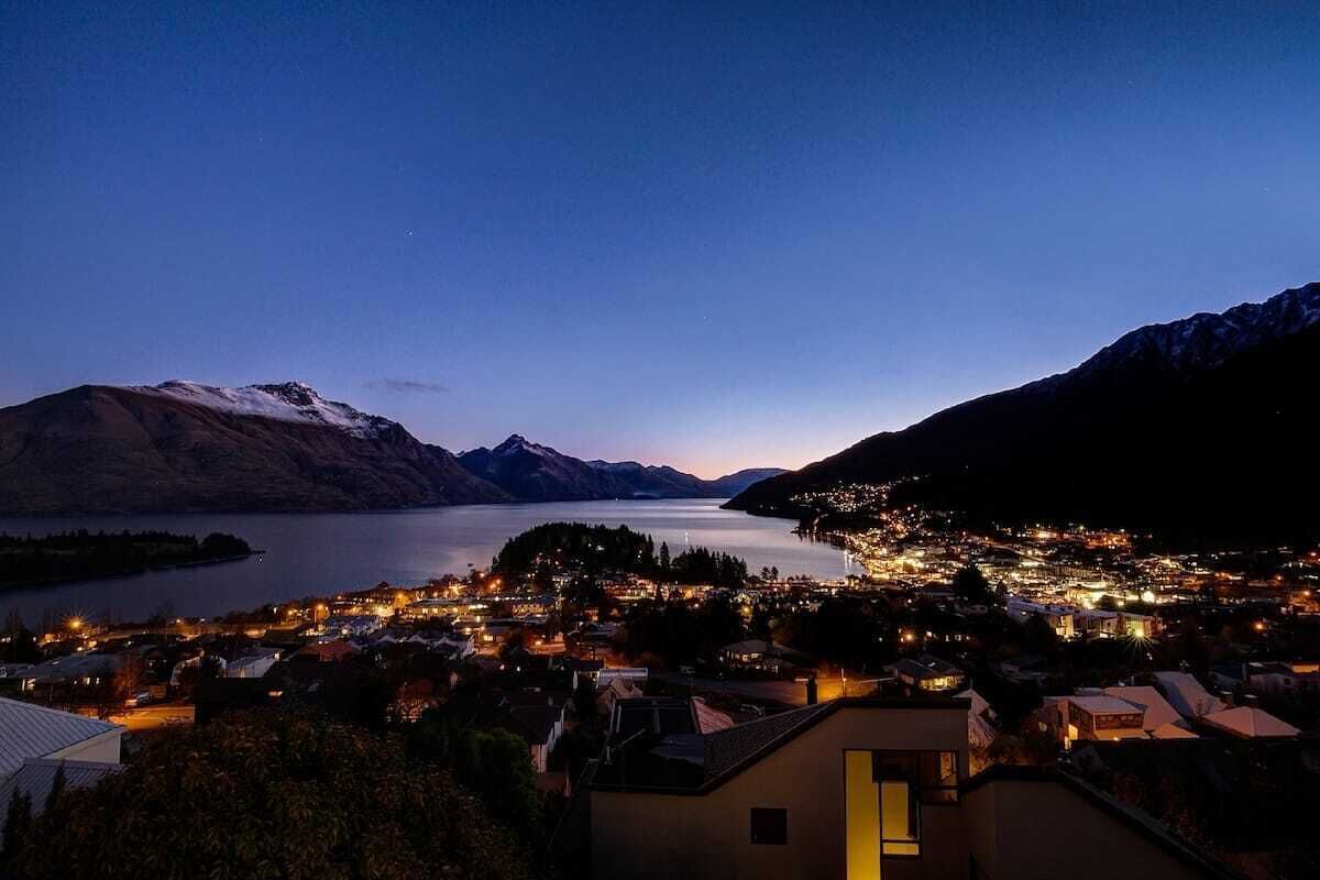 A town by a lake with mountains in the background.
