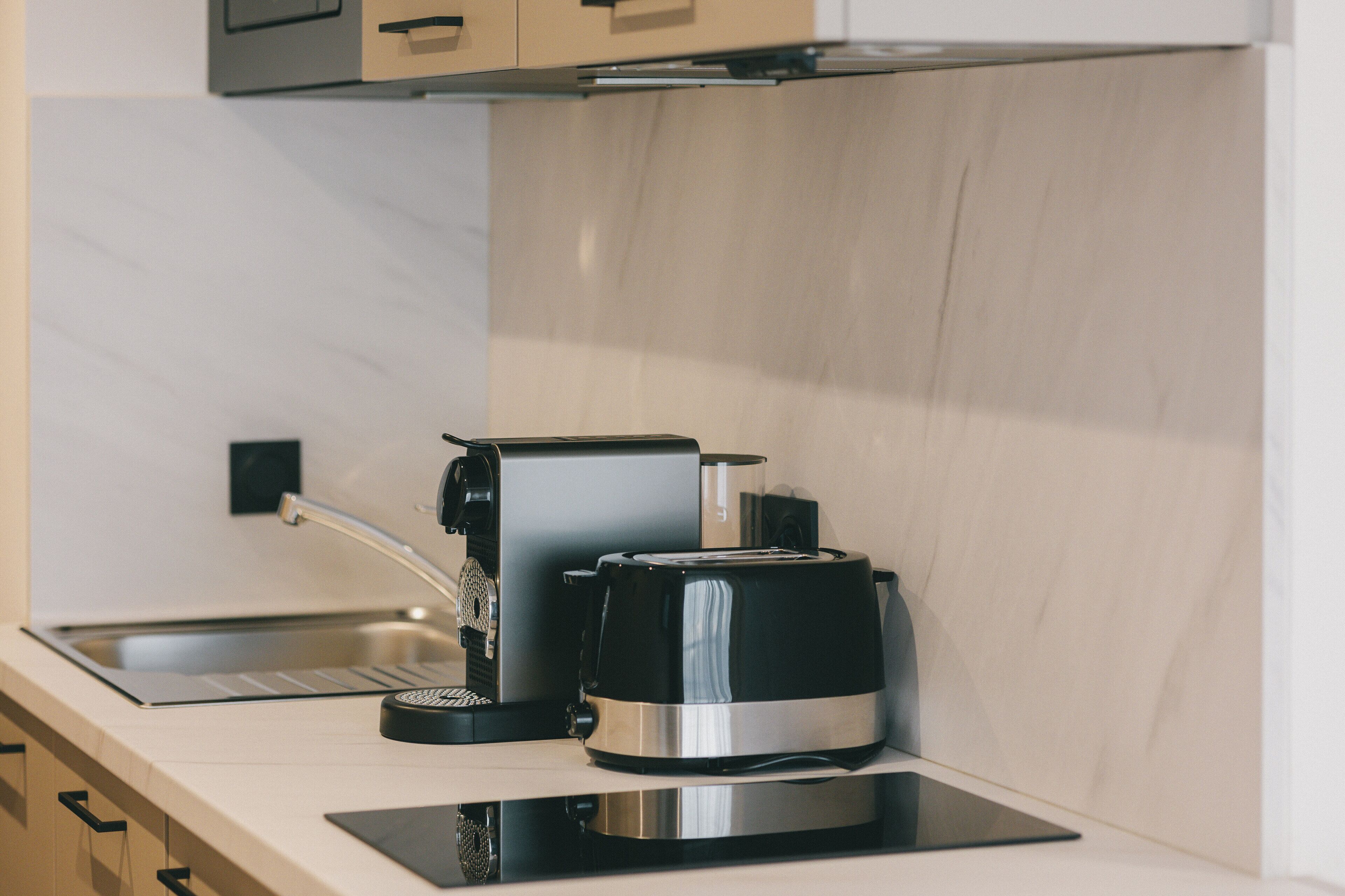 A kitchen with a coffee maker and a toaster on a countertop.