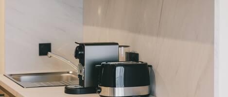 A kitchen with a coffee maker and a toaster on a countertop.
