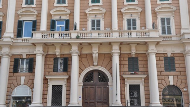 A classical building facade with symmetrical windows, columns, and a central arched entrance. - Numa Roma GuestHouse (Rome)
