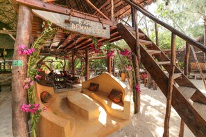 Relax in a natural atmosphere with a wooden staircase leading to a cozy seating area.