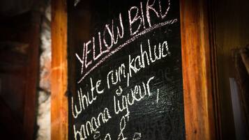 A chalkboard with a menu listing items such as 'White rum, kahu, banana liqueur, passion fruit juice'.