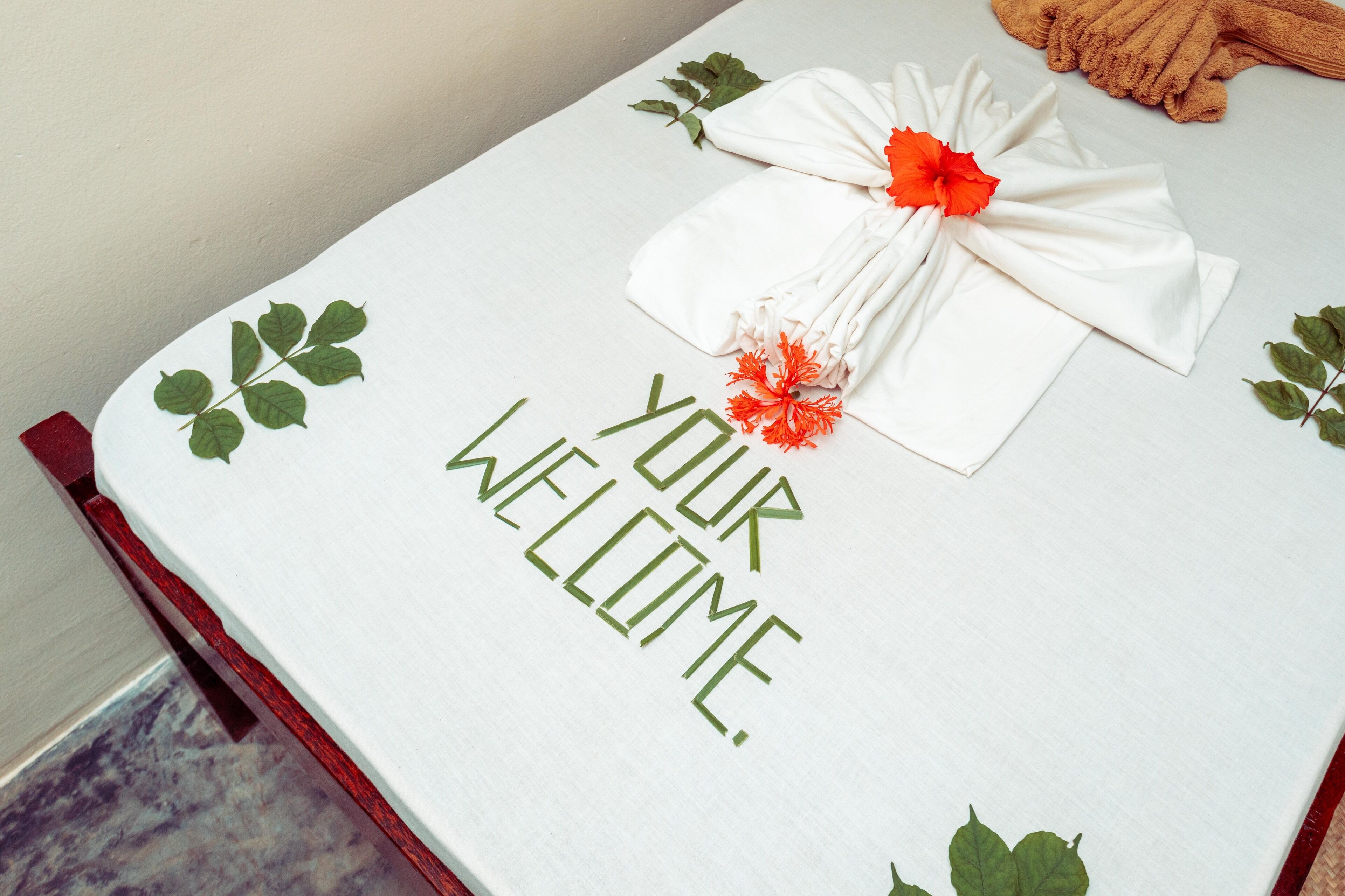 A welcome mat with "YOUR WELCOME" text and decorative leaves.