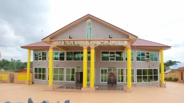 A building with a sign reading "CBAVS GOLDEN PLAZA HOTEL". - Obaa'S Golden Plaza Hotel (New Abirem)