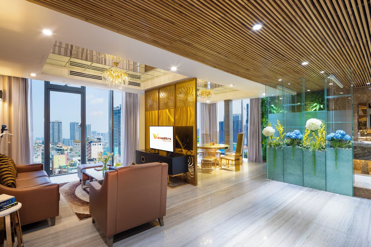 A modern hotel lobby with a city view, a reception desk, and a seating area with a view.