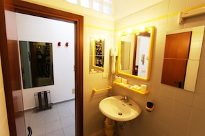 A bathroom with a sink, mirrors, and a hand dryer. - Logicasa Lake in Como (Como)