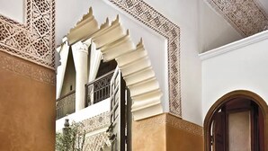 An ornate architectural detail with intricate patterns and a balcony. - Riad Al Loune (Marrakech)