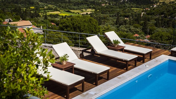 A poolside area with lounge chairs and a view of a lush landscape. - Iconic Villas, Villa Rosa with private pool and stunning mountain view (Drakopoulata)