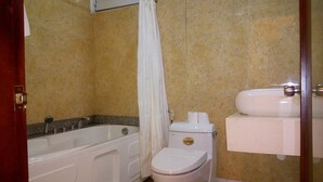 A bathroom with a bathtub, toilet, and sink. - Classic Room- Free Laundry Services in District 1 (District 1)