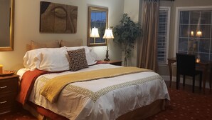 A neatly arranged bedroom with a bed, bedside tables, a desk, and a ceiling fan. - Amazing W Marietta 5BR-3BA Relocation, Long Stay (Marietta)