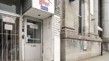 A hotel entrance with a sign reading "Homa Hotel" and a door marked with the number 4258.