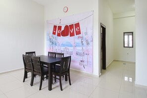 Enjoy meals in this dining area with a large table and four chairs.