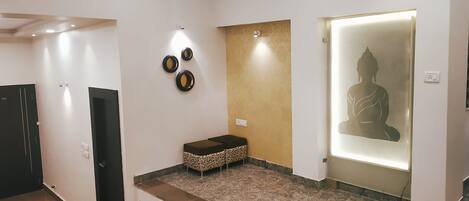 A modern interior with a reception area, a staircase, and a wall with decorative plates.