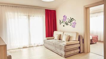 Junior Suite, Balcony | Living area | Flat-screen TV