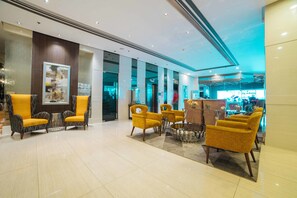 A lobby with modern furniture, a glass partition, and a reception area. - RedDoorz Premium @ West Avenue Quezon City (Quezon City)
