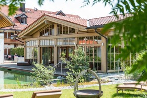 A two-story building with large windows and a red-tiled roof. - Posthotel Hofherr (Konigsdorf)