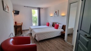 A room with two beds, a red chair, a wooden desk, and a TV on the wall. - Le Pradet Hotel (Vacqueyras)