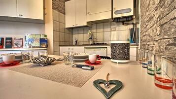 Studio, 1 Bedroom | Private kitchen | Full-sized fridge, stovetop, cookware/dishes/utensils