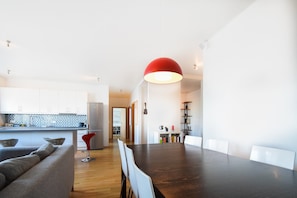 Enjoy meals around the central dining table, surrounded by comfortable chairs.