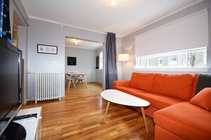 Relax in this spacious living room with a sofa, coffee table, and dining area.