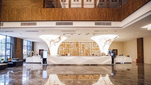 A spacious lobby with a marble floor, a reception desk, and a high ceiling with wooden paneling. - Best Western Plus Qingxinyuan Hotel Zhangjiajie (Zhangjiajie)