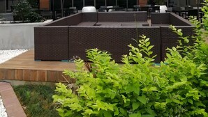 A modern building with a courtyard featuring outdoor seating and umbrellas. - Best Western Plus Qingxinyuan Hotel Zhangjiajie (Zhangjiajie)