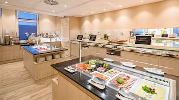 A buffet with various food items and a glass display case.