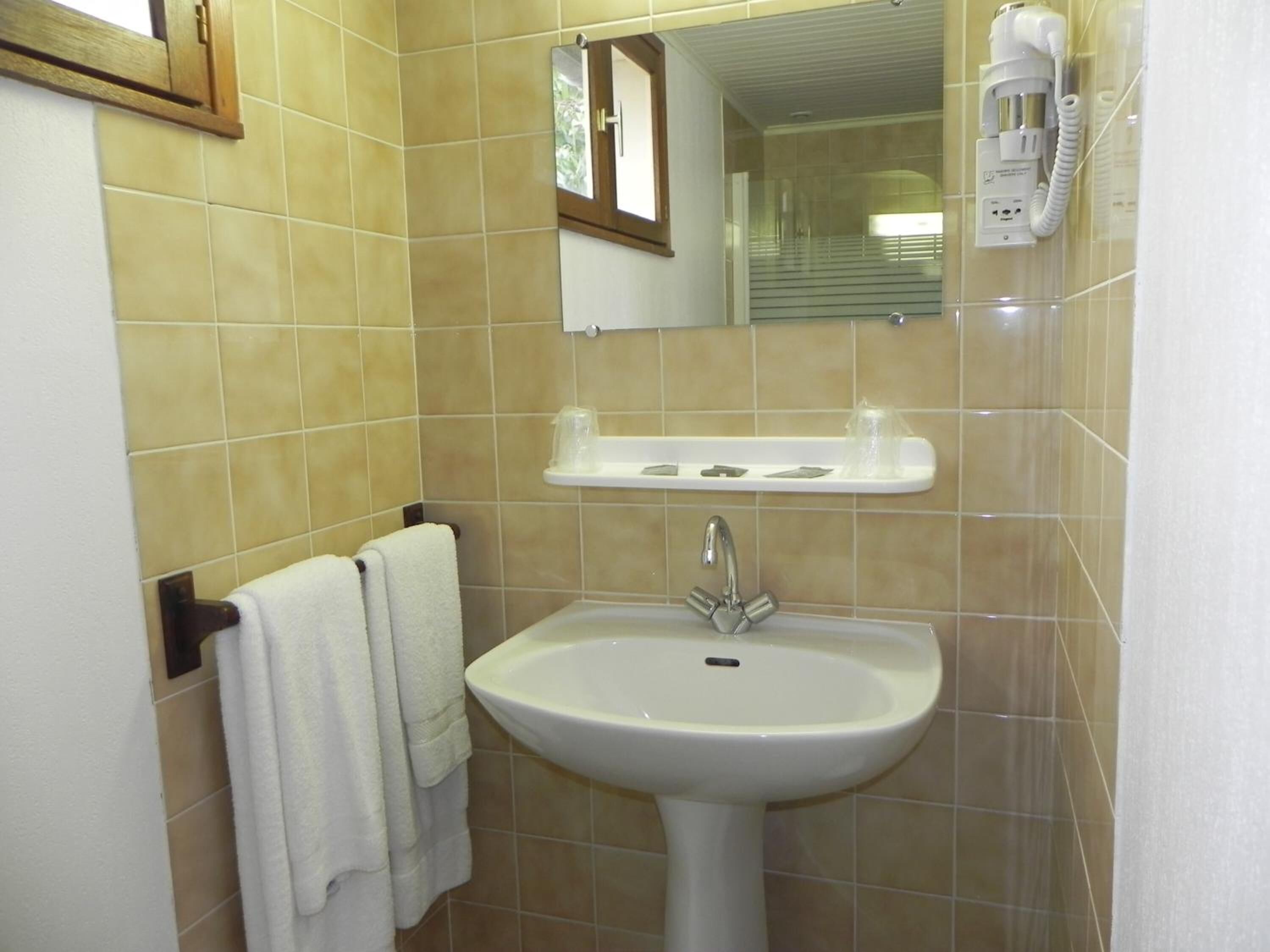 bathtub, hair dryer, towels