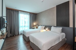 A hotel room with two beds, a desk, a TV, and a large window with curtains. - O&G Hotel Parit Buntar (Parit Buntar)