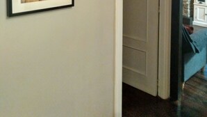 A framed poster of mushrooms on a wall, a doorway leading to another room, and a light fixture above the poster. -  4 LIRONES - THE 4 SLEEPYHEAD DORMOUSES  (Benasque)