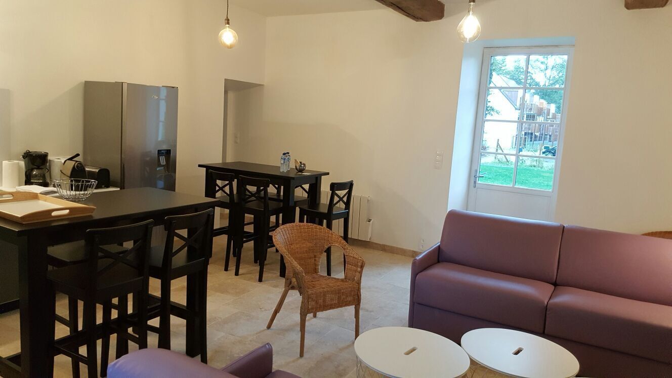 A compact living space with a kitchenette, dining area, and seating area.