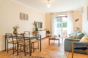 Apartment, 1 Bedroom, Balcony, Garden View | Living area | Flat-screen TV, DVD player, iPod dock - LV Premier Troia - TR1 (Grandola)