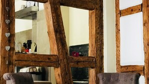 A rustic room with exposed wooden beams, a large mirror, and two upholstered chairs. - CHARACTER GITE with TERRACE and GARDEN, SPACIOUS and QUIET  (Gueberschwihr)