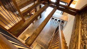 A high-ceilinged interior with exposed wooden beams and a central staircase. - CHARACTER GITE with TERRACE and GARDEN, SPACIOUS and QUIET  (Gueberschwihr)
