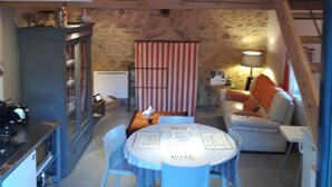 A loft-style living space with a dining area, kitchen, and a loft bed. -  comfortable cottages in character farmhouse located in Drôme Provençal (Grillon)